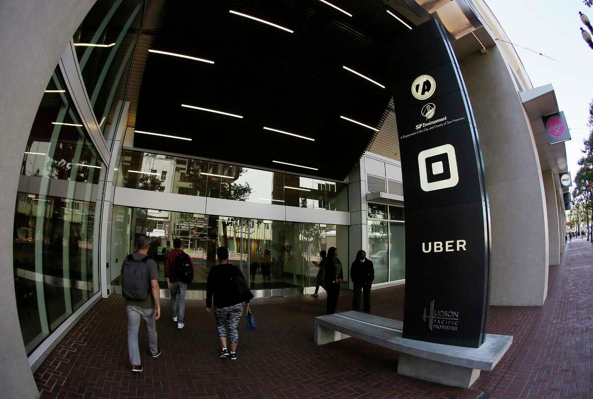 People make their way Wednesday into the building that houses the headquarters of Uber in San Francisco.
