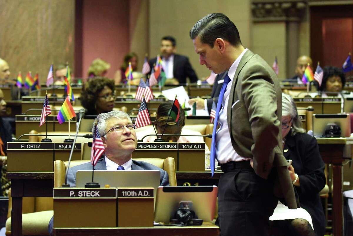 Assemblyman Angelo Santabarbara, right, stops by Assemblymember Phil Steck?’s desk to talk during session in the Assembly on Wednesday, June 21, 2017, at the Capitol in Albany, N.Y. (Will Waldron/Times Union)