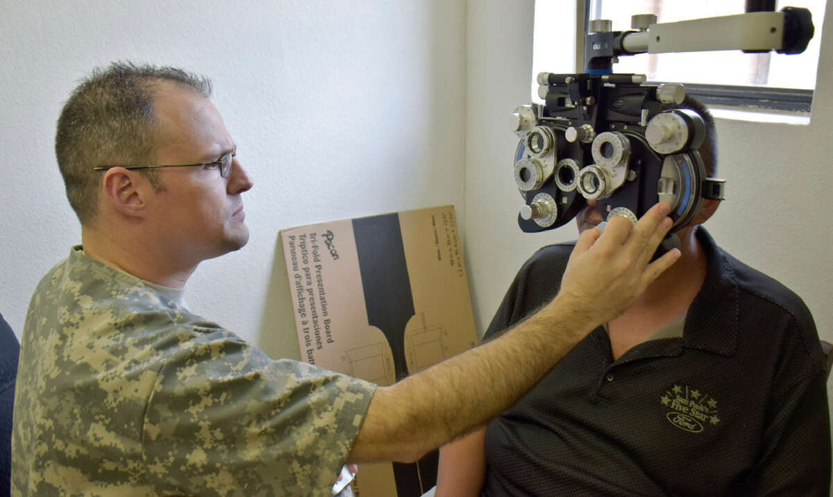 Captain Rolando Ortiz assists Lucio Torres with helping him find the right prescription for his glasses as part of the Operation Health & Wellness in collaboration with Texas A& Colonias Program, Army Reserve and Webb County at Larga Vista Community Center. The 7458th Medical Backfield Battalion in collaboration with the Texas A& systems provided medical, dental, and optometry services to the patients that arrived at the center.