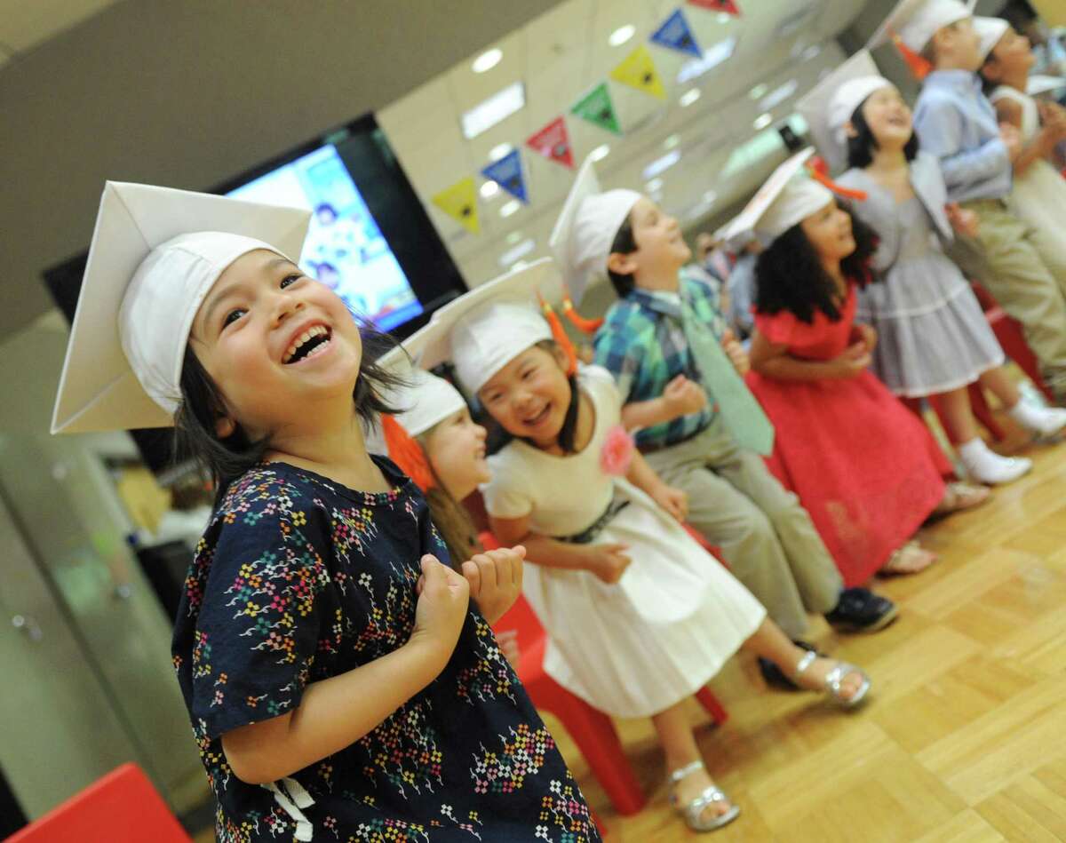 Avery Huang-Lopez performs a dance with fellow students during the Fours Moving Up Ceremony at the YWCA's Steven & Alexandra Cohen Preschool Center in Greenwich, Conn. Thursday, June 22, 2017. A dozen students wore graduation caps and performed song and dance routines in celebration for moving up to the next level at the YWCA.