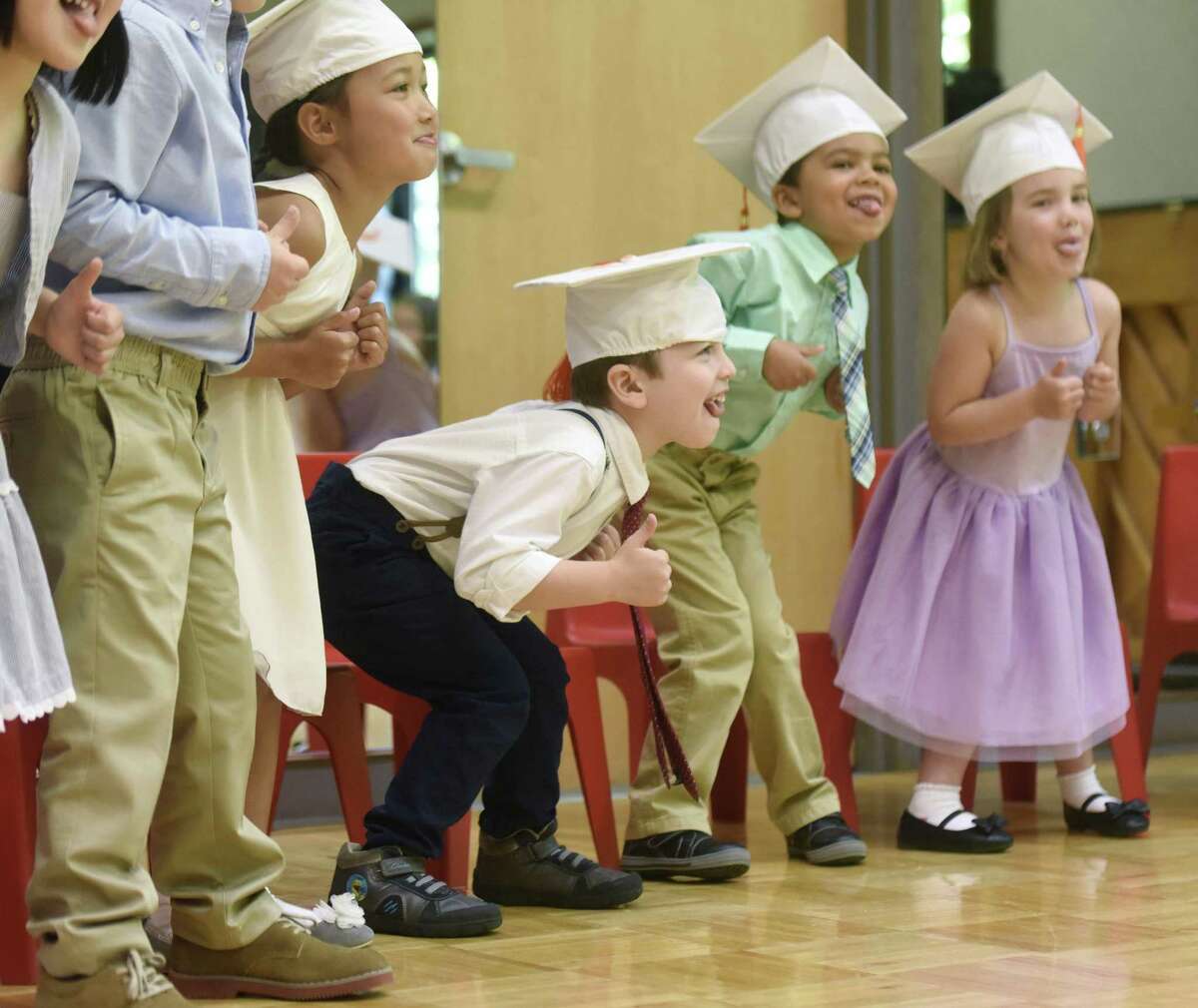 From left, Annemijn Kooyman, Richard Congiu, Brandon Dougherty, and Philippa Haag-Fisk perform a choreographed dance during the Fours Moving Up Ceremony at the YWCA's Steven & Alexandra Cohen Preschool Center in Greenwich, Conn. Thursday, June 22, 2017. A dozen students wore graduation caps and performed song and dance routines in celebration for moving up to the next level at the YWCA.