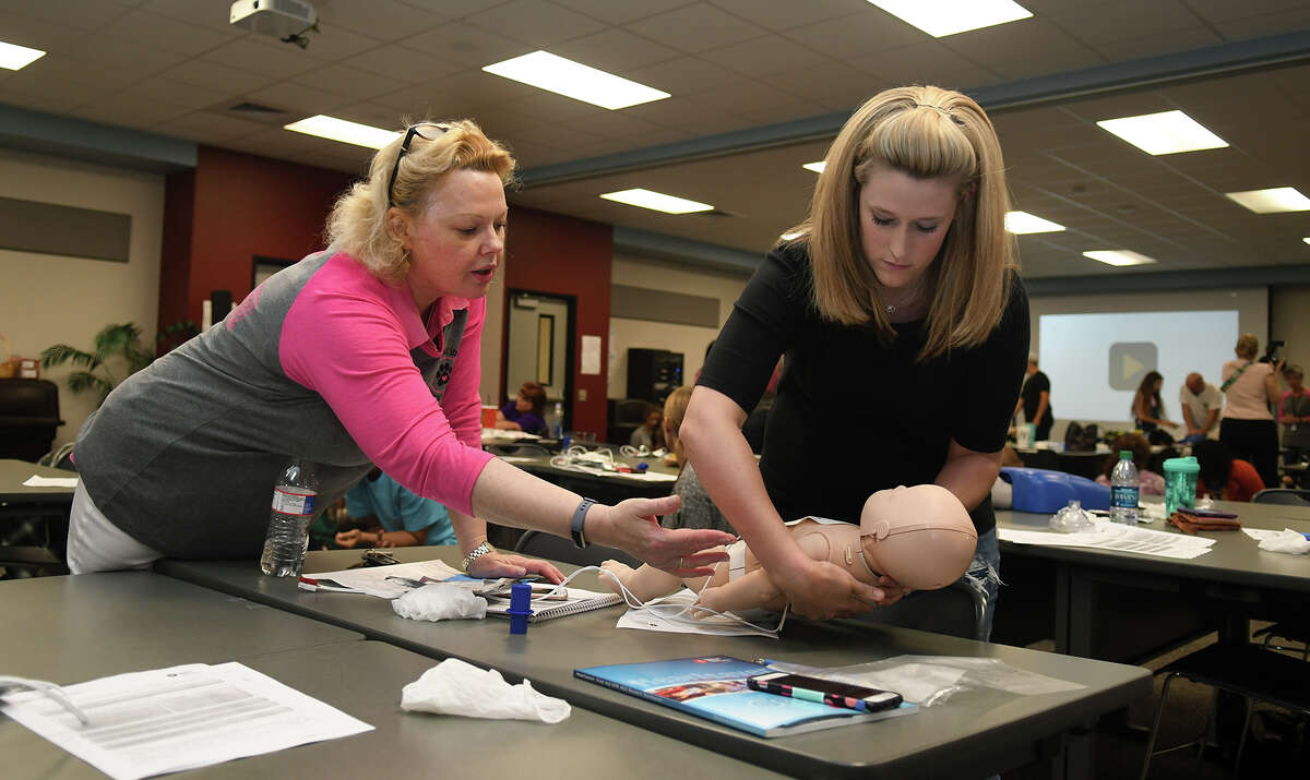 Tomball ISD Nurse Mary Barry, left, helps Lauren Sheppard, a stay-at-home mom and former Tomball ISD teacher, during a her CPR/AED and First Aid Certification class at the Tomball ISD Staff Development Center in Tomball on June 20, 2017. (Photo by Jerry Baker/Freelance)