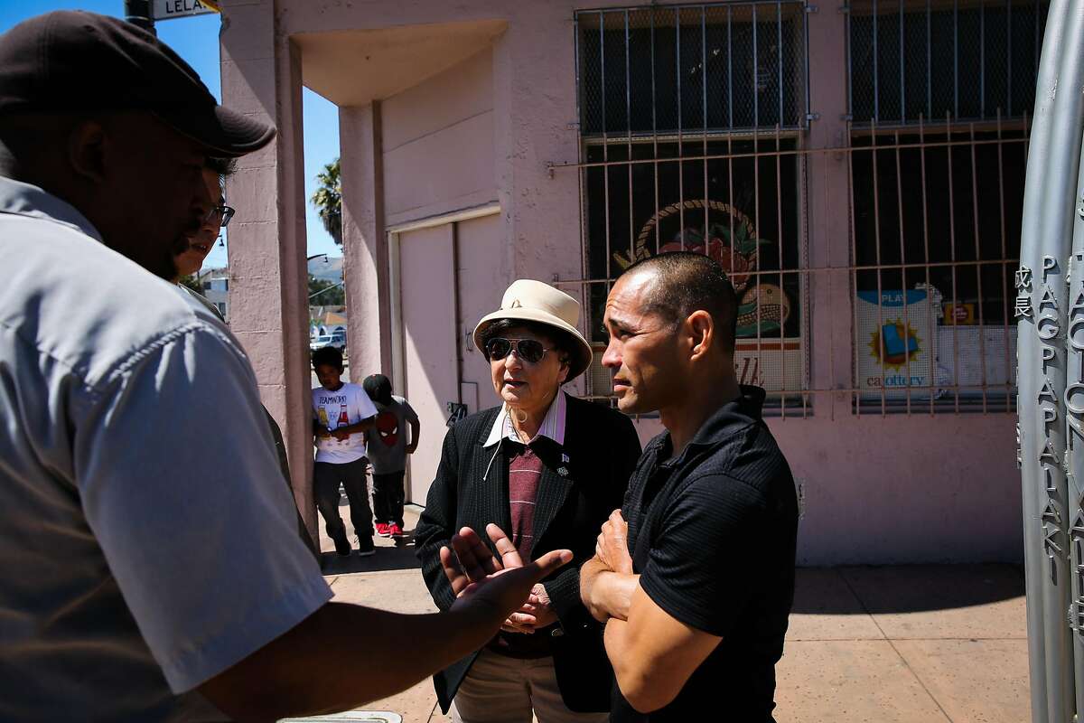 (l-r) Community advocate Russel Morine and spokeswoman for the Visitation Valley Asian alliance Marlene Tran chat with executive director of Real Options for City Kids Curt Yagi (right) outside a building that is being proposed to become a medical marijuana dispensary in San Francisco, California, on Wednesday, June 21, 2017. They are all opposed to the dispensary.