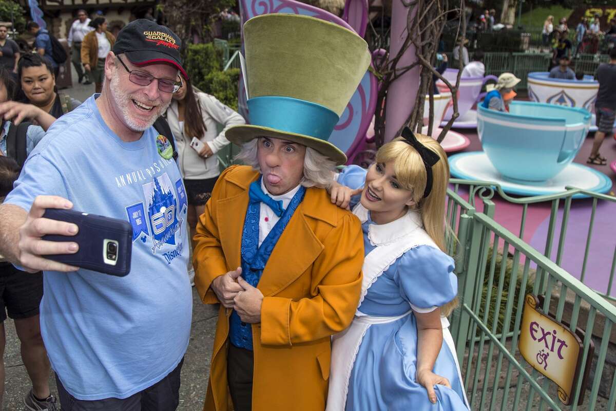 ANAHEIM, Calif. - Thursday, June 22, 2017: Huntington Beach resident Jeff Reitz, who has visited the parks of the Disneyland Resort every day since January 1, 2012, marked his 2,000th consecutive visit on Thursday. Here, Reitz snaps a selfie with The Mad Hatter and Alice after a teacup ride at the Mad Tea Party in Fantasyland at Disneyland during his 2,000th visit to the park. (Joshua Sudock/Disneyland Resort)