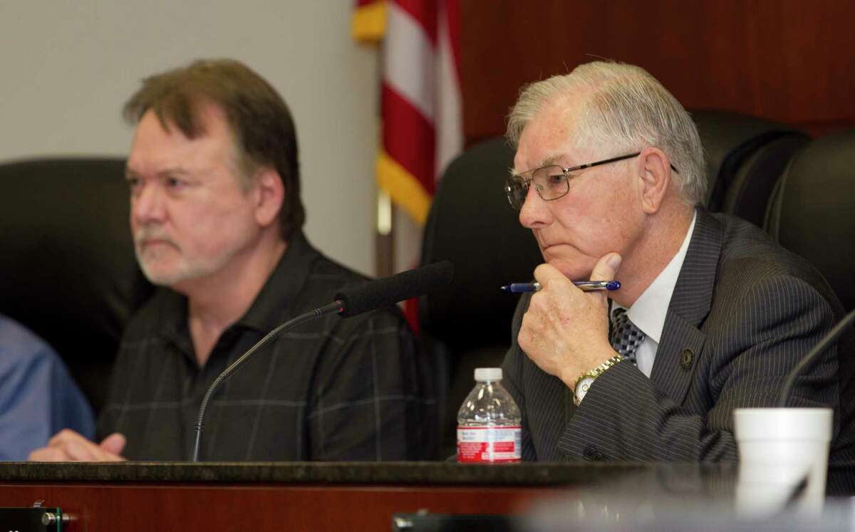 Conroe Mayor Toby Powell, right, listens along side city council member Guy Martin during a city council meeting at Conroe Tower Thursday, Feb. 23, 2017, in Conroe. SLIDESHOW: Texas towns with odor problems