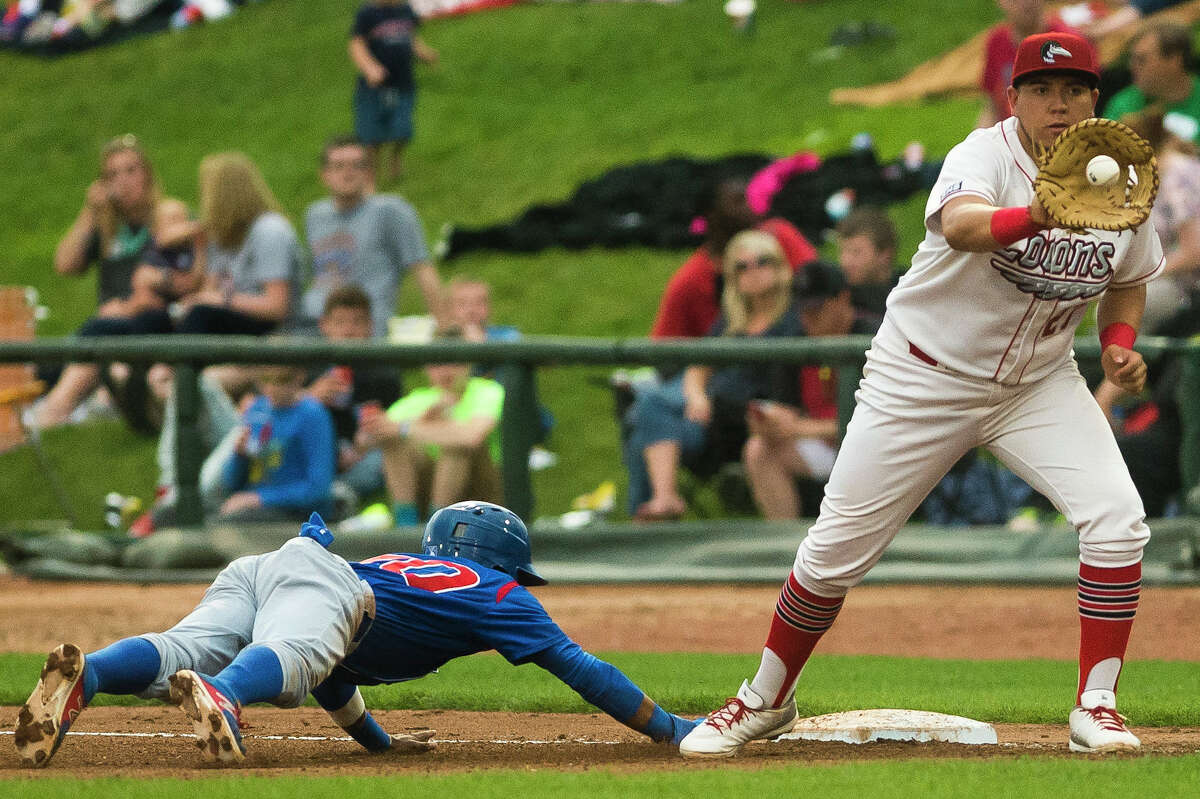 Great Lakes Loons' Eric Meza catches a throw as South Bend's Yeiler Peguero slides back into first base during their game on Thursday, June 22, 2017 at the Dow Diamond.