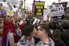 LOS ANGELES, CA - JUNE 11: Men kiss in defiance of a counter protest from provocative street preachers at the #ResistMarch during the 47th annual LA Pride Festival on June 11, 2017, in the Hollywood section of Los Angeles and West Hollywood, California. Inspired by the huge women's marches that took place around the world following the inauguration of President Donald Trump and by the early pride demonstrations of the 1970s, LA Pride replaced its decades-old parade with the #ResistMarch protest to promote human rights by marching from Hollywood to West Hollywood.  (Photo by David McNew/Getty Images)