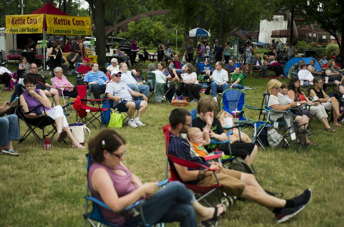 People wait for music to start during Tunes by the Tridge on Thursday, June 22, 2017 in Chippewassee Park.