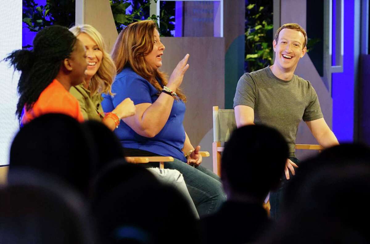 Facebook CEO Mark Zuckerberg, right, speaks with panelists at the Facebook Communities Summit, Thursday, June 22, 2017, in Chicago. Zuckerberg announced a new Facebook initiative designed to spur people to form more meaningful communities with Facebook's groups feature. From left are Lola Omolola, Erin Schatteman and Janet Sanchez, who run popular Facebook groups. (AP Photo/Teresa Crawford)
