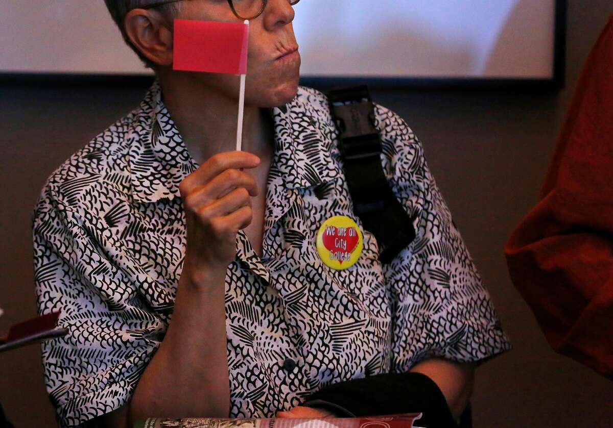 Retired faculty member Karen Saginor listens to testimony and holds a small red flag meant to symbolize negative "red flags" people perceived to find on the new chancellor pick during a CCSF board of trustees meeting to vote to approve the new chancellor, Mark Rocha, in the multi-use building June 22, 2017 in San Francisco, Calif.
