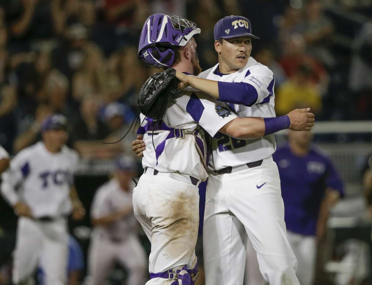 TCU pitcher Sean Wymer, right, hugs catcher Evan Skoug after the last out against Louisville in an NCAA College World Series baseball elimination game in Omaha, Neb., Thursday, June 22, 2017. TCU won 4-3. (AP Photo/Nati Harnik)