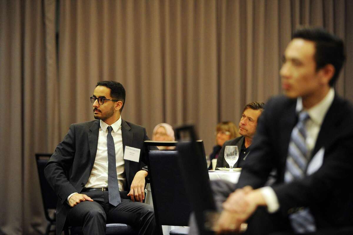 Albaraa Alyamani, a recent graduate of UConn's graduate risk management program, listens to presidential historian Douglas Brinkley give the keynote speech during the UConn Risk Management Conference at the Crowne Plaza Stamford hotel in Stamford, Conn. on Wednesday, June 21, 2017.