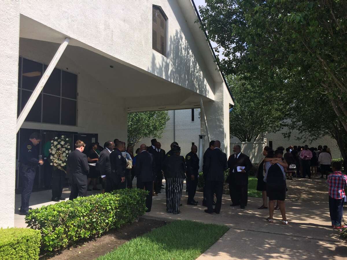 Mourners console each other at The Church at Bethel's Family June 23, after the funeral for 10-month old Messiah Marshall, who was shot to death June 14.