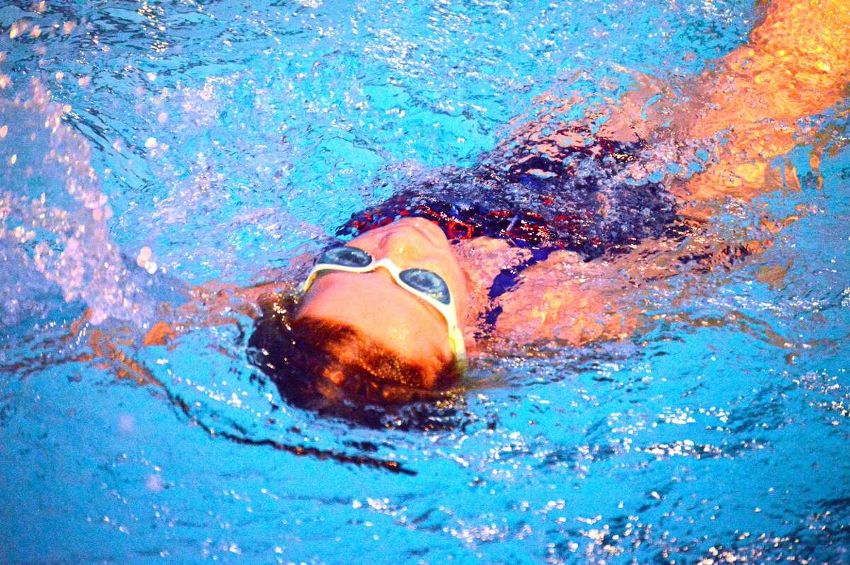 Water Works swimmer Avery Marsh competes in the fourth heat of the 25-meter backstroke in the 7-8 girls division in a dual meet against Splash City in Edwardsville.