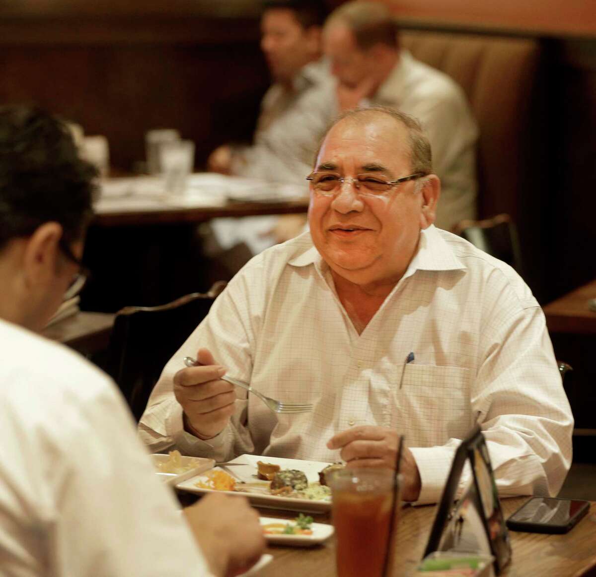 Koroush Sheikhi, left, and Bal K. Sareen, right, dine at Peli Peli, 5085 Westheimer Rd., Tuesday, June 20, 2017, in Houston. ( Melissa Phillip / Houston Chronicle )