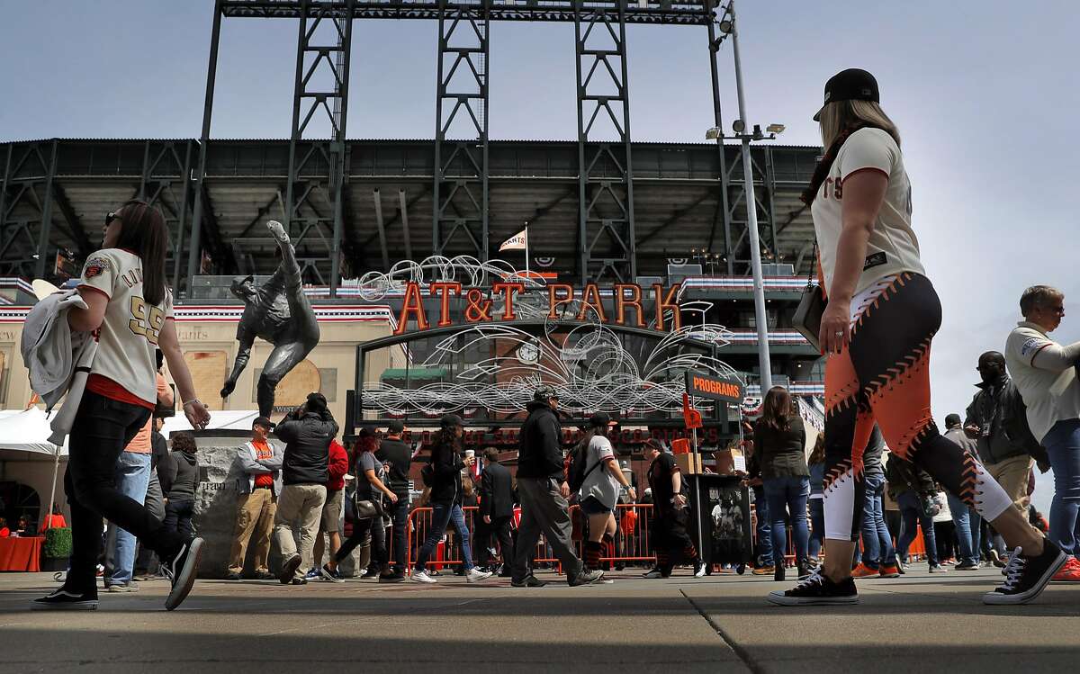 FILE-- Fans walk past the Juan Marichal statue at the Lefty O'Doul gate before the San Francisco Giants played the Arizona Diamondbacks on opening day at AT&T Park in San Francisco on Monday, April 10, 2017.