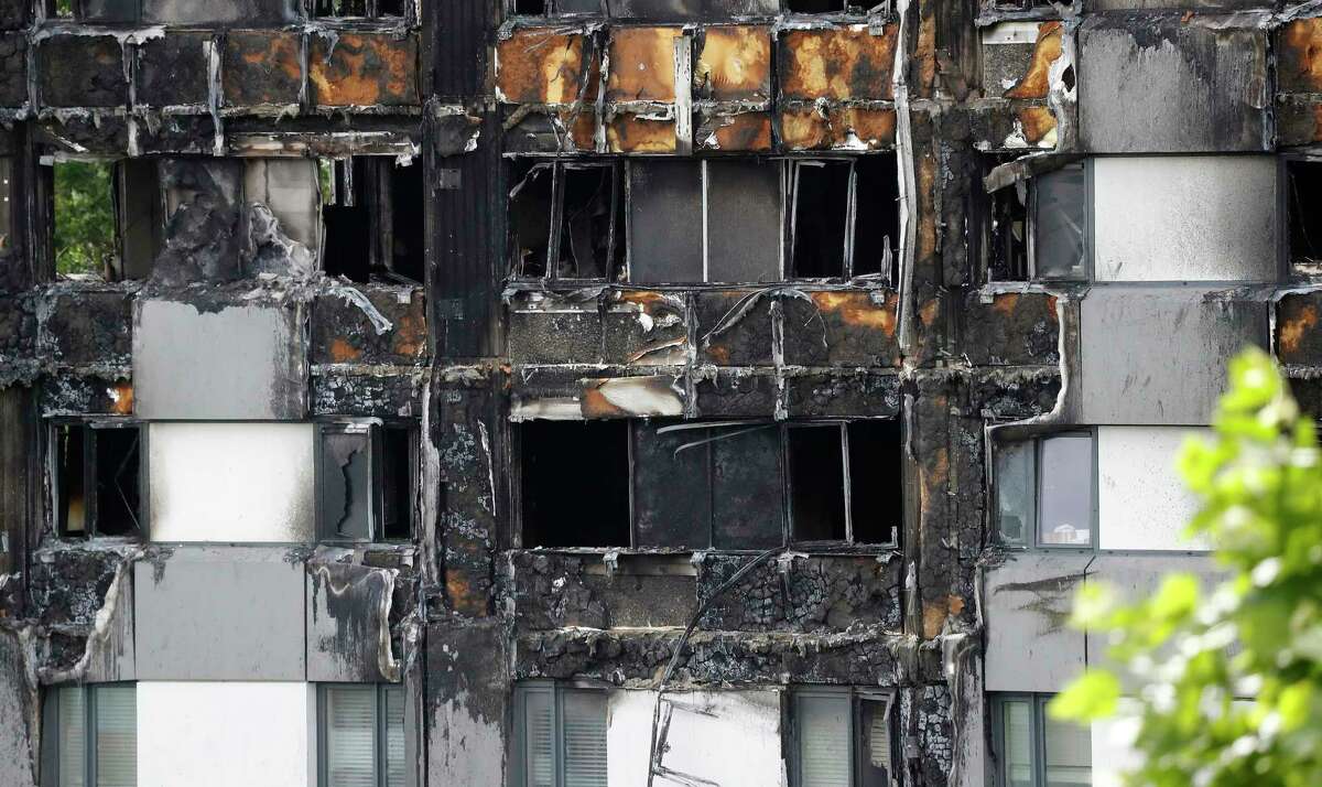 One of the lowest apartments which is gutted by fire in the burnt Grenfell Tower apartment building standing testament to the recent fire in London, Friday, June 23, 2017. British officials have ordered an immediate examination Friday, into a fridge-freezer that is deemed to have started the fire in the 24-storey high-rise apartment building early morning of June 14th, and the outside cladding of the building which is thought to have helped spread the fire, according to police, leaving dozens dead.(AP Photo/Frank Augstein)