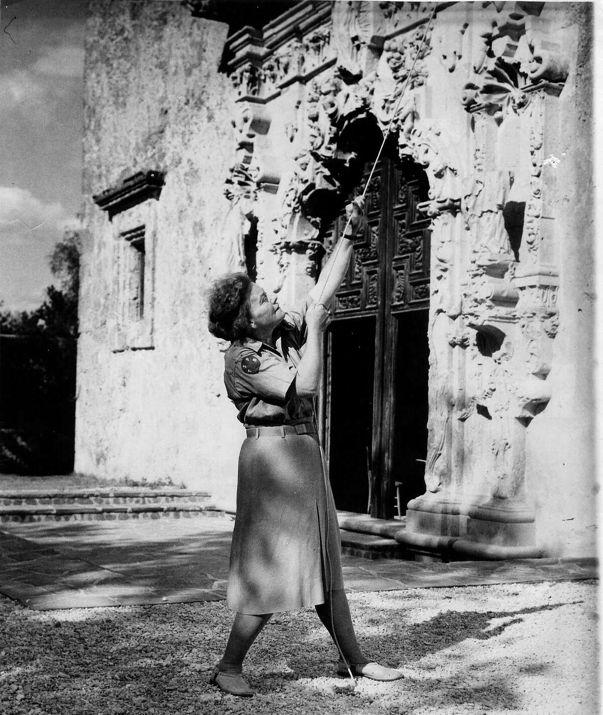 Ethel Wilson Harris rings the San José Mission bell in her Texas State Parks Board uniform, circa 1941.