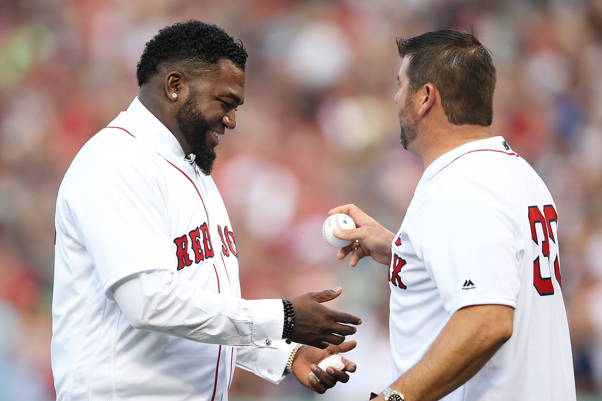 Boston Red Sox baseball great David Ortiz, right, laughs with Hall of Fame  pitcher Pedro Martinez, Friday, June 23, 2017, at Fenway Park in Boston as  the team retired Ortiz's jersey No.