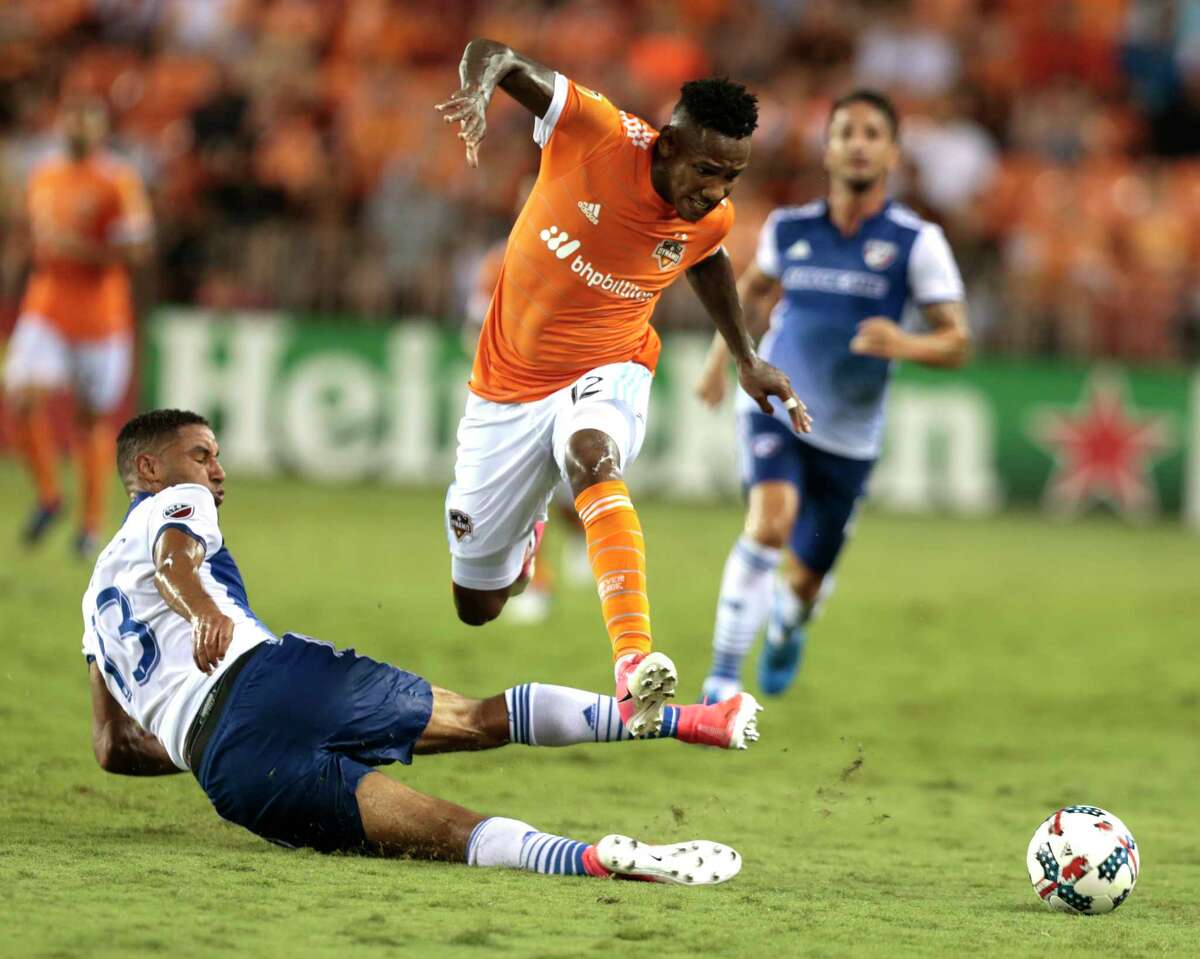 ﻿Dynamo forward Romell Quioto leaps over FC Dallas forward Tesho Akindele ﻿going after a ball during the first half ﻿of Friday's ﻿draw at BBVA Compass Stadium. The teams remain tied for second in the Western Conference.