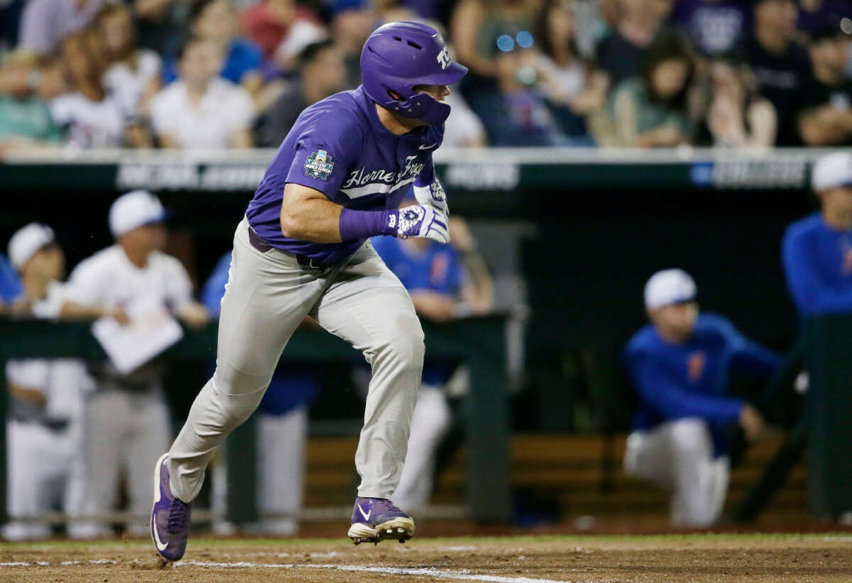 TCU's Austen Wade runs to first base, where he was safe on a play at another base during the sixth inning of the team's NCAA College World Series baseball game against Florida in Omaha, Neb., Friday, June 23, 2017. (AP Photo/Nati Harnik)