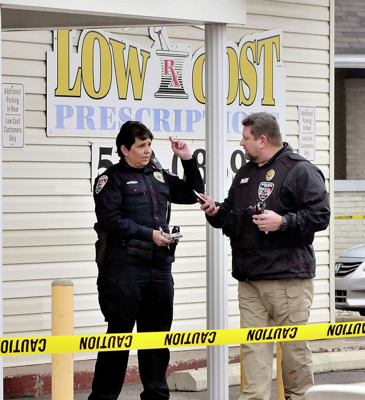 In this Jan. 25, 2107 photo, Elwood, Ind. police investigate an armed robbery at Low Cost Prescriptions in Elwood, Ind., where one robbery suspect was shot and wounded by police. Law enforcement and pharmacies in Indiana are fighting back against a wave of pharmacy robberies that followed a state crackdown on opioid abuse. Those pill-robbing crimes surged in the state during 2015, when Indiana topped the nation with 168 such heists targeting painkillers and other potent drugs. (John P. Cleary /The Herald-Bulletin via AP)