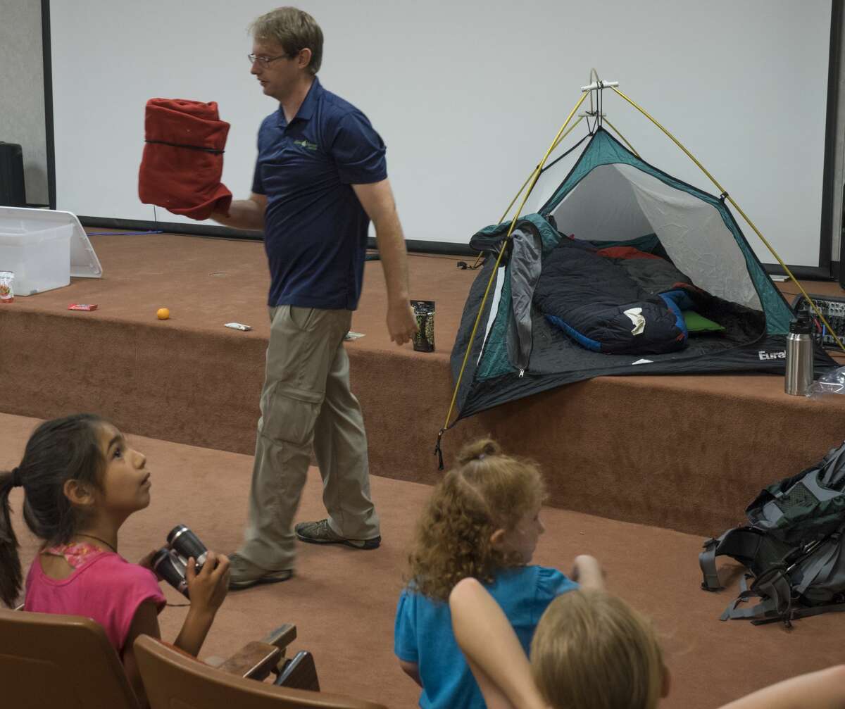 Jeremy Clothier, with Sibley Nature Center, talks with youngsters on proper camping and hiking safety 6/24/17. Tim Fischer/Reporter-Telegram