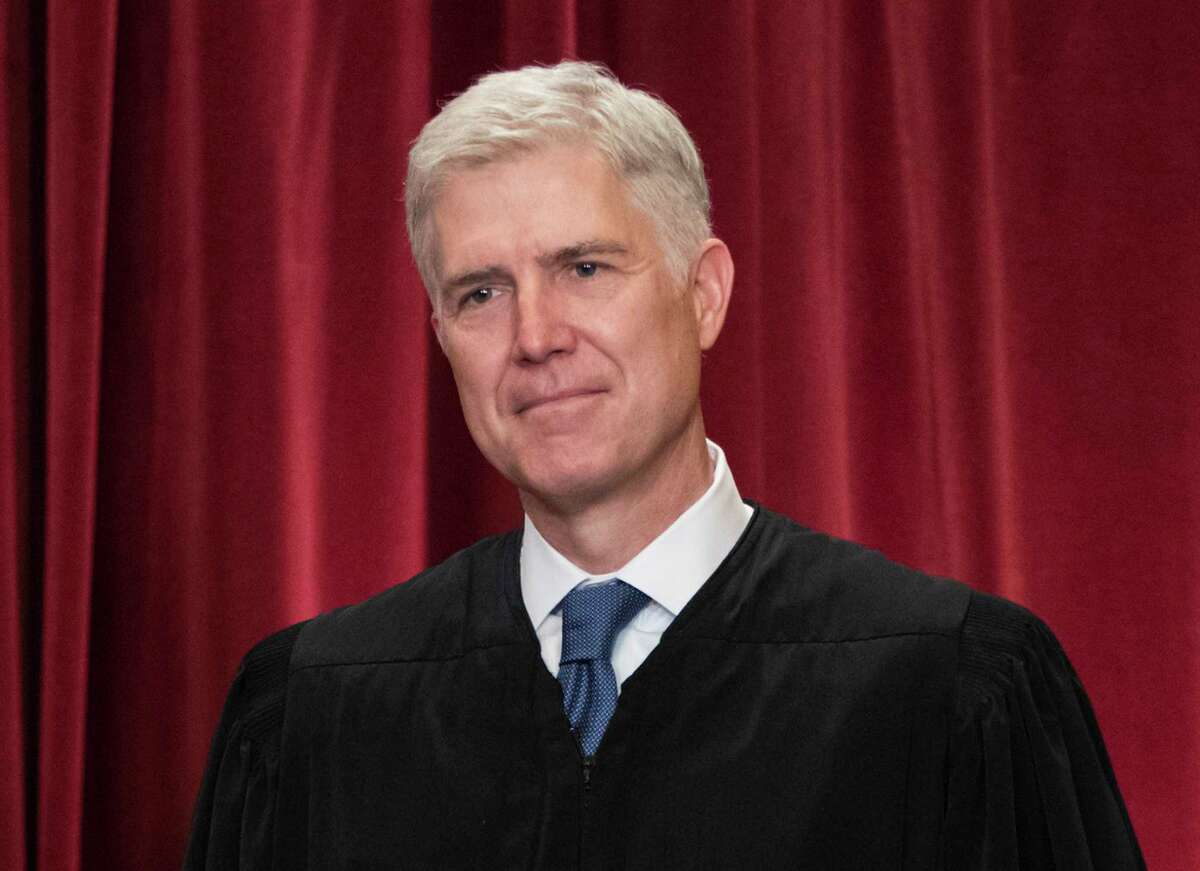 FILE - In this June 1, 2017, file photo Supreme Court Associate Justice Neil Gorsuch is seen during an official group portrait at the Supreme Court Building Washington. For those wondering where Gorsuch will fit on the Supreme CourtÂs ideological spectrum, the best early clue might be to watch the company he keeps. Gorsuch has already paired up four times with Justice Clarence Thomas _ the courtÂs most conservative member _ in separate opinions that dissent from or take issue with the courtÂs majority rulings. (AP Photo/J. Scott Applewhite, File)