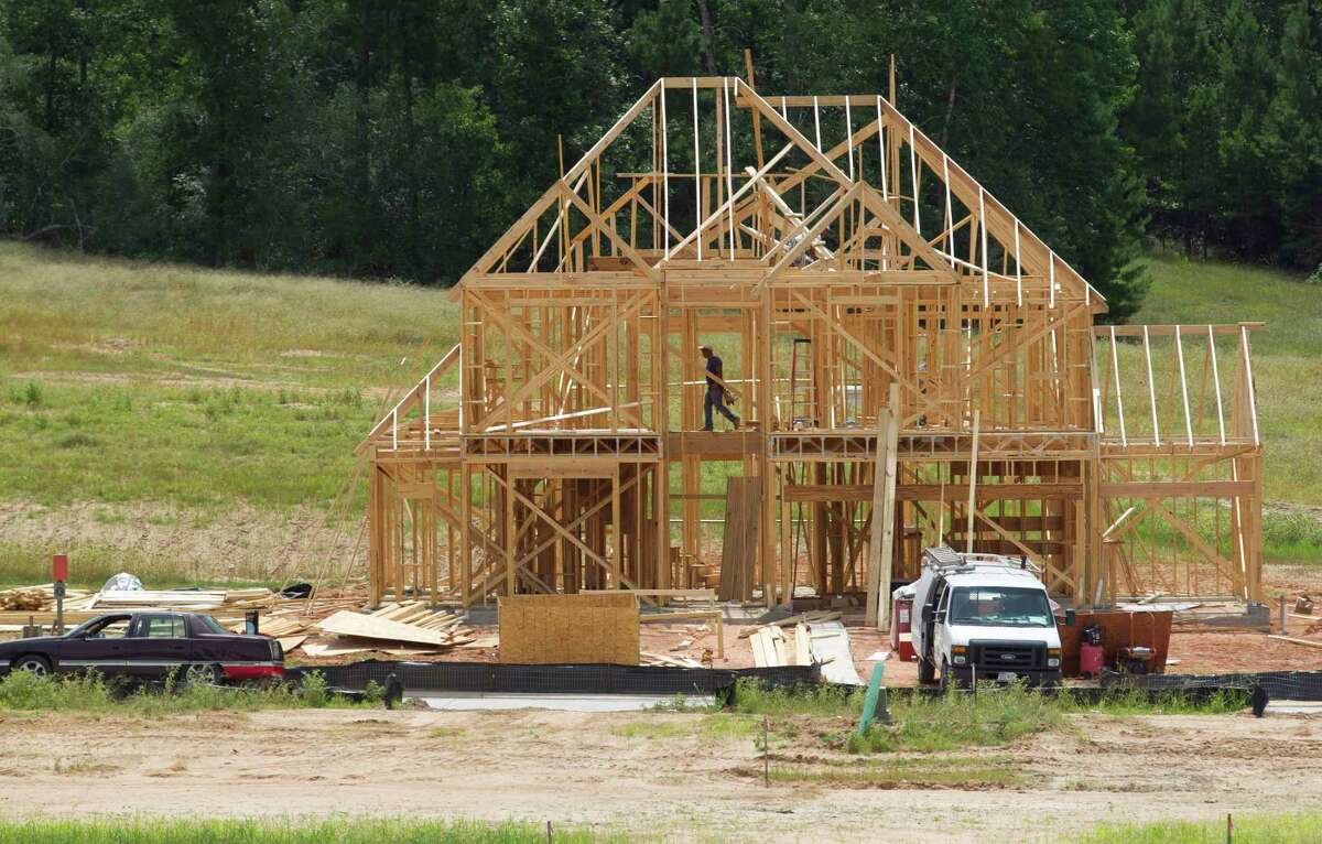 Construction of a new home in the Wedgewood Forest subdivision continues Wednesday, June 21, 2017, in Conroe.