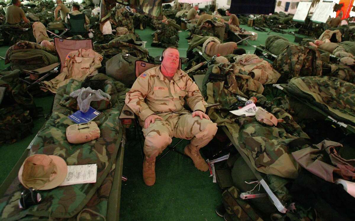 3-3-04 Sgt. David Medzyk cq, from California catches up on his sleep during a break from Wednesday's training. Medzyk is a member of the California National Guard 40th ID that is attached to Washington National Guard181 support battalion that is currently under going training at the US Army's National Training Center at Ft. Irwin in California's Mojave Desert. The men and women of the 181st along with elements of National Guards units from California and Minnesota will be deployed to Iraq later this month.