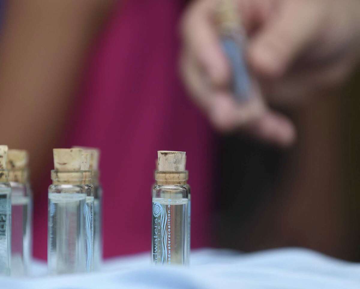 Vials of water taken from the Blue Hole, the headwater of the San Antonio River, are made available to people attending an event called "Standing with the Paris Climate Agreement, Celebrating and Dancing with Creation," on Saturday, June 24, 2017. A statement from the Sisters of Charity of the Incarnate Word expressing concern with President Trump's decision to remove the United States from the climate deal was read.
