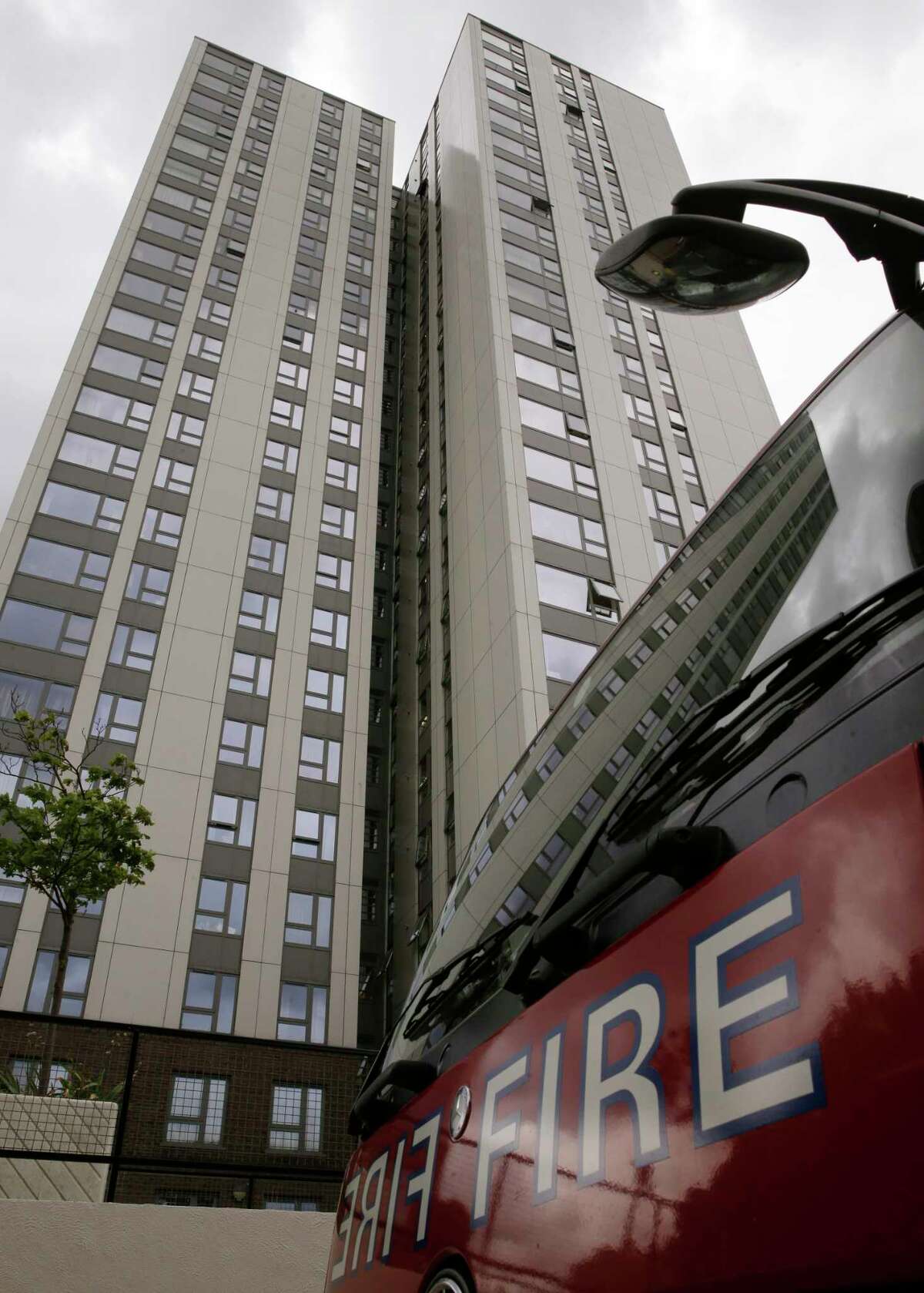 A fire engine is parked outside Burnham block, part of the Chalcots Estate in the borough of Camden, north London, Saturday June 24, 2017, after the local council evacuated some 650 homes overnight. The apartments were evacuated overnight after fire inspectors concluded that the buildings, in north London's Camden area, were unsafe because of problematic fire doors, gas pipe insulation, and external cladding similar to that blamed for the rapid spread of a fire that engulfed Grenfell Tower on June 14. (AP Photo/Alastair Grant) ORG XMIT: LON175