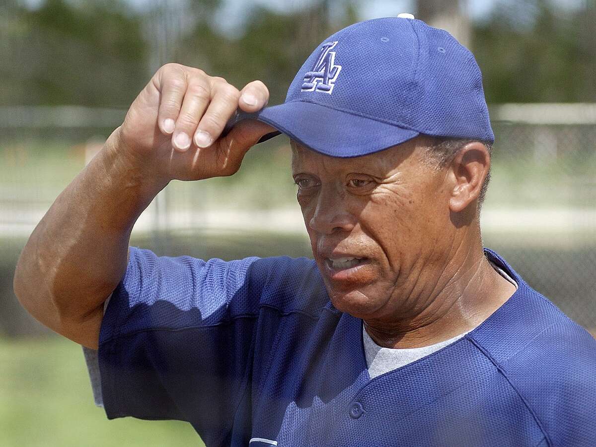 FILE - In this Feb. 26, 2003 file photo, Los Angeles Dodgers bunting and base running coordinator Maury Wills adjusts his cap during spring training at Dodgertown in Vero Beach, Fla. Former Los Angeles Dodgers great Wills has retired again, this time from broadcasting. The 84-year-old Wills is stepping out of the Fargo-Moorhead RedHawks' broadcast booth after providing color commentary for the minor league team for 22 years.(AP Photo/Richard Drew, File)