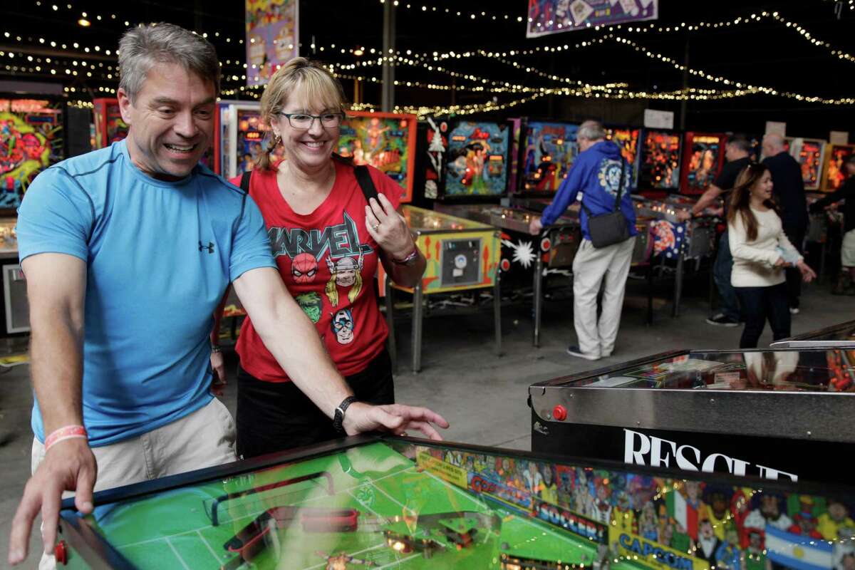 Jim and Ellyn Derby play during the Moon Pinball Expo at the Pacific Pinball Musem in Alameda last year.