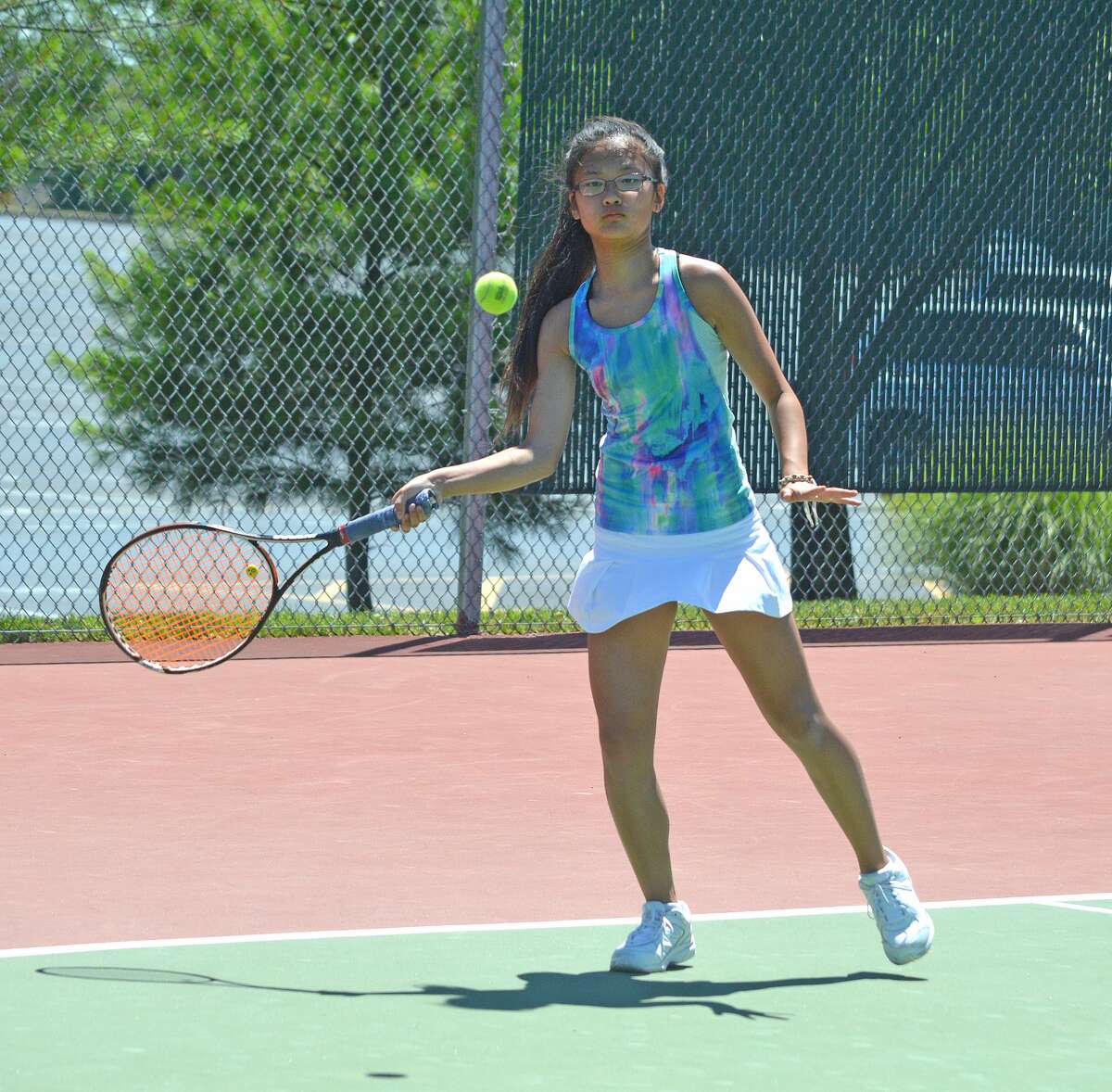 Chloe Koons, who will be a seventh-grader at Liberty Middle School, makes a forehand return during her girls’ 12 singles final at the Tiger Tennis Classic on Sunday.