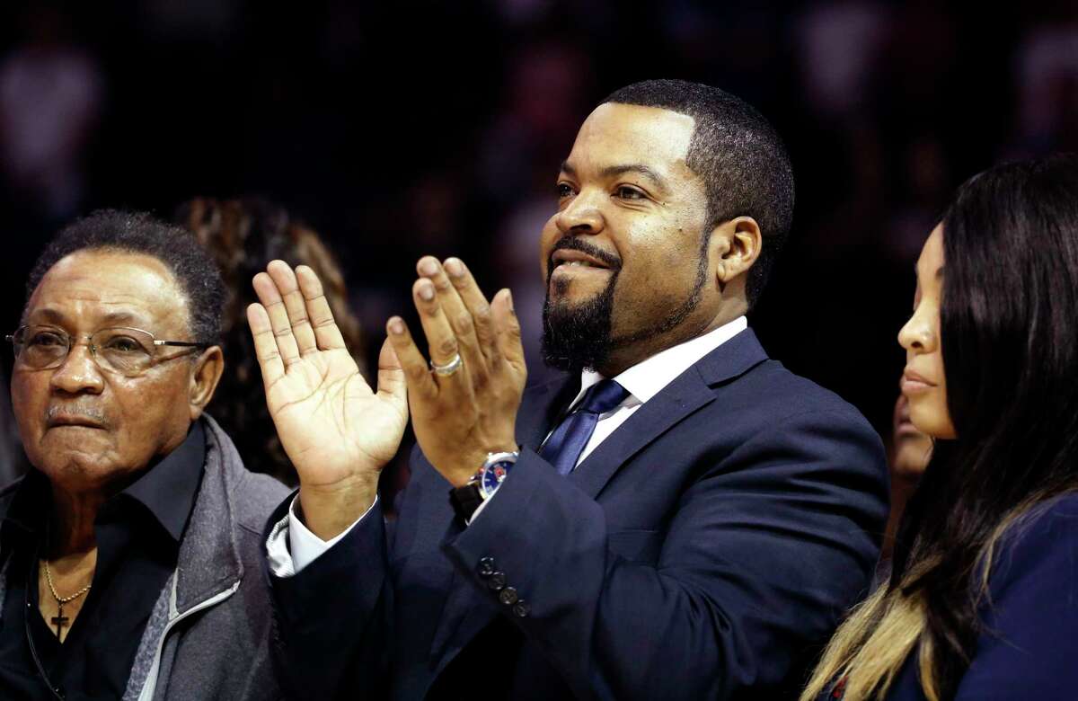 BIG3 Basketball League founder Ice Cube, center, applauds during Game 1 of the league's debut, Sunday, June 25, 2017, at the Barclays Center in New York. (AP Photo/Kathy Willens)