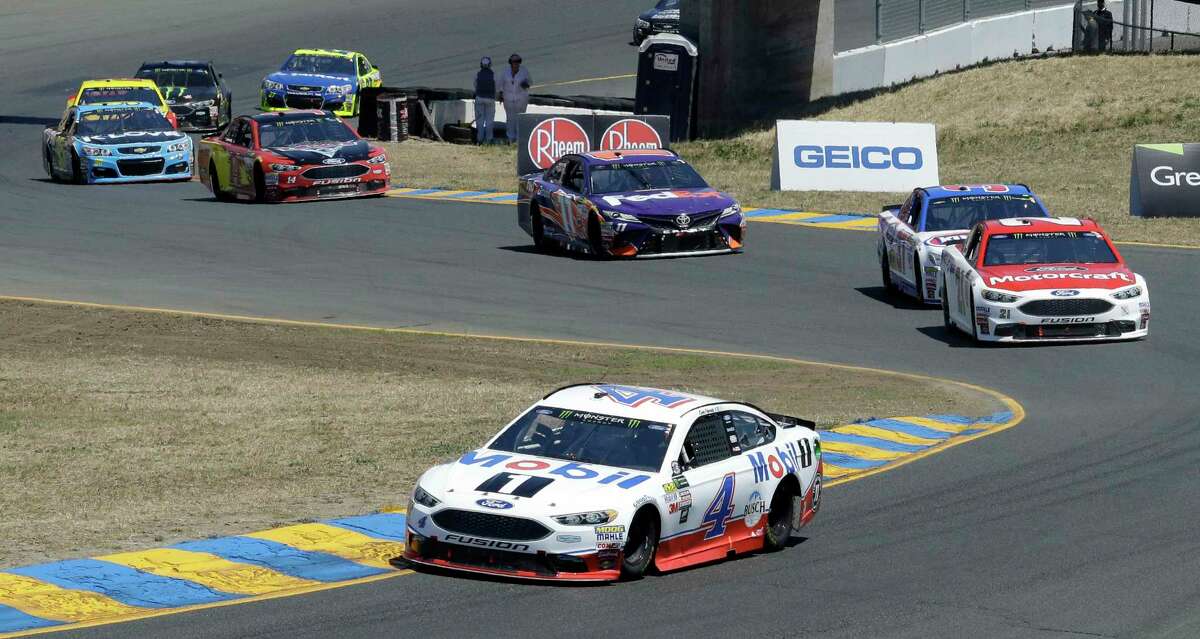 Kevin Harvick (4) leads through a turn during the NASCAR Sprint Cup Series auto race Sunday, June 25, 2017, in Sonoma, Calif. (AP Photo/Ben Margot)