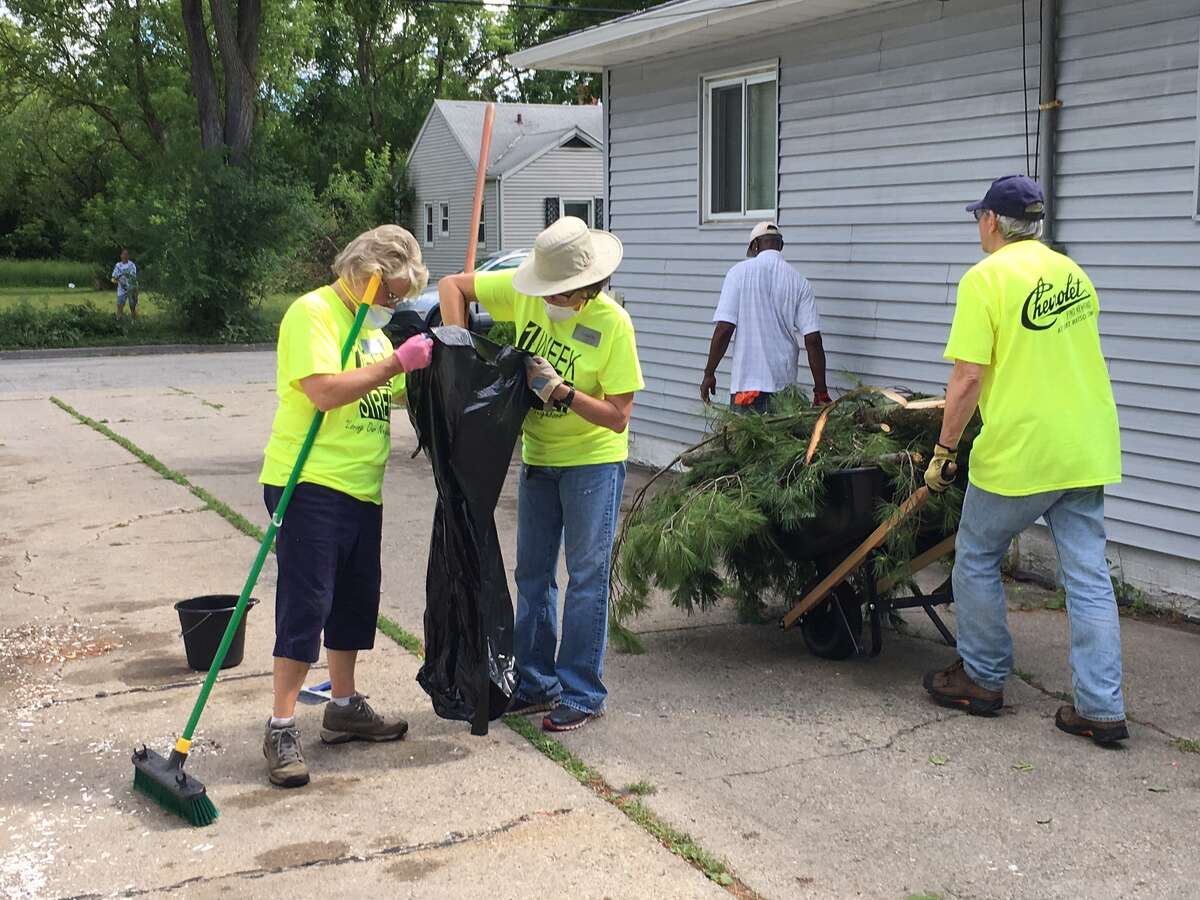 Linda Yoder, Laura Perkins and Greg Janoch volunteer during One Week One Street June 2017 in Saginaw.