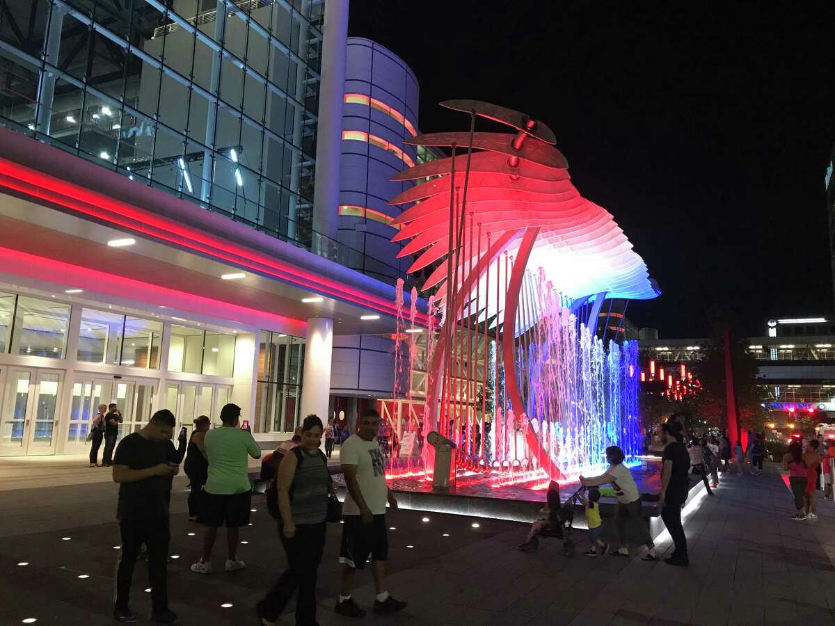 Visitors enjoy the "Wings over Water" sculpture that's installed within a fountain front of the George R. Brown Convention Center.