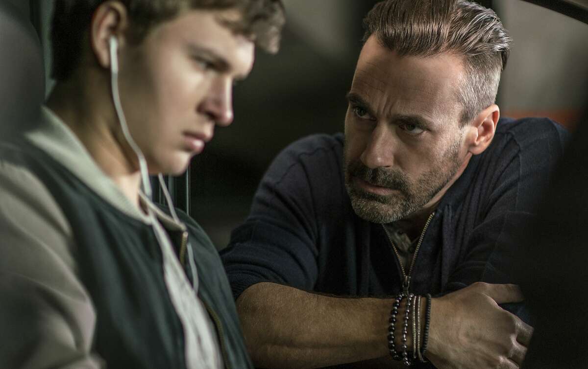 This image released by Sony/TriStar shows Ansel Elgort, left, and Jon Hamm in a scene from the film, "Baby Driver." (Wilson Webb/Sony/TriStar via AP)