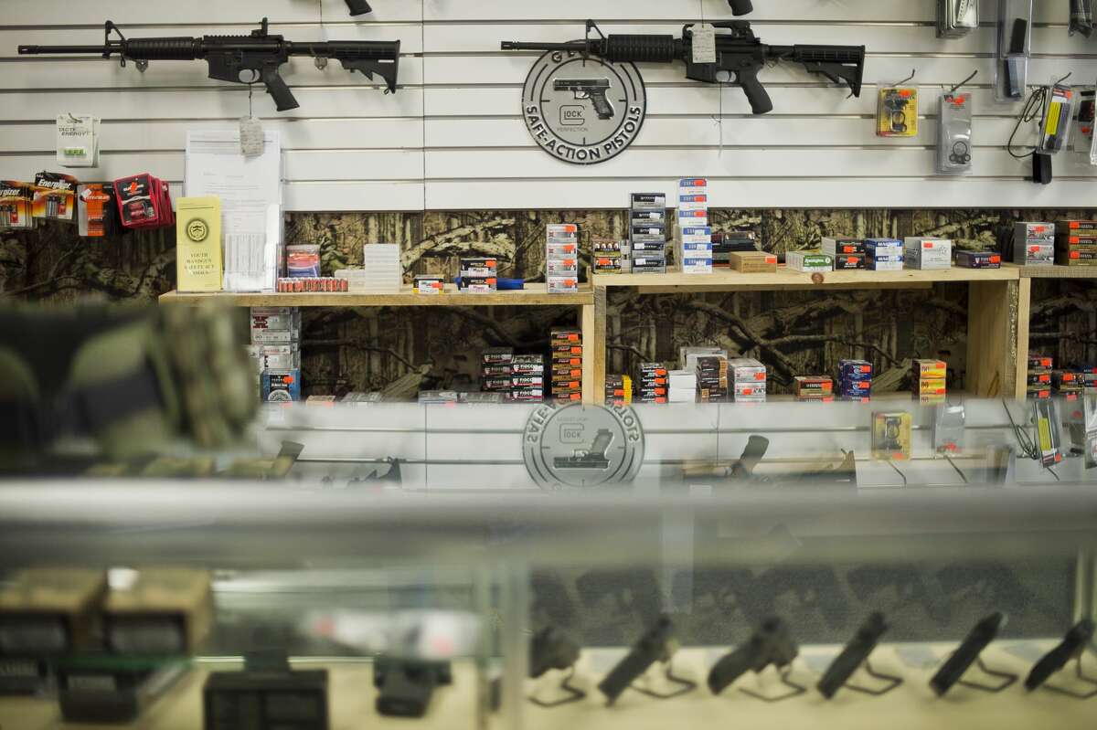 Rifles, handguns and ammunition are displayed inside Midland Arms & Defensive Solutions, a gun shop that offers CPL courses, on Wednesday, June 21, 2017.