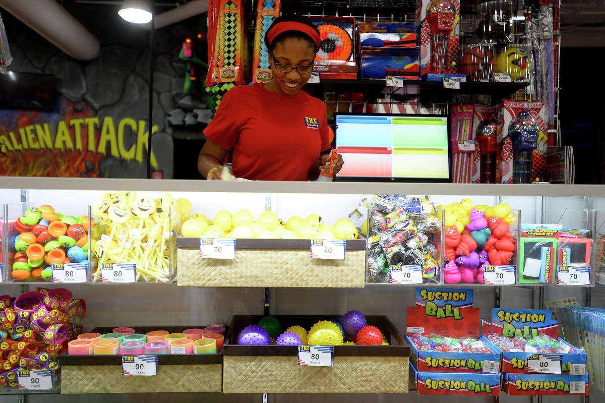 Cristina Franklin cleans the prize counter at Tilt Studio in Parkdale Mall on Thursday afternoon. Franklin is working this summer to help pay for her upcoming freshman year at Grambling State University. Photo taken Thursday 6/22/17 Ryan Pelham/The Enterprise