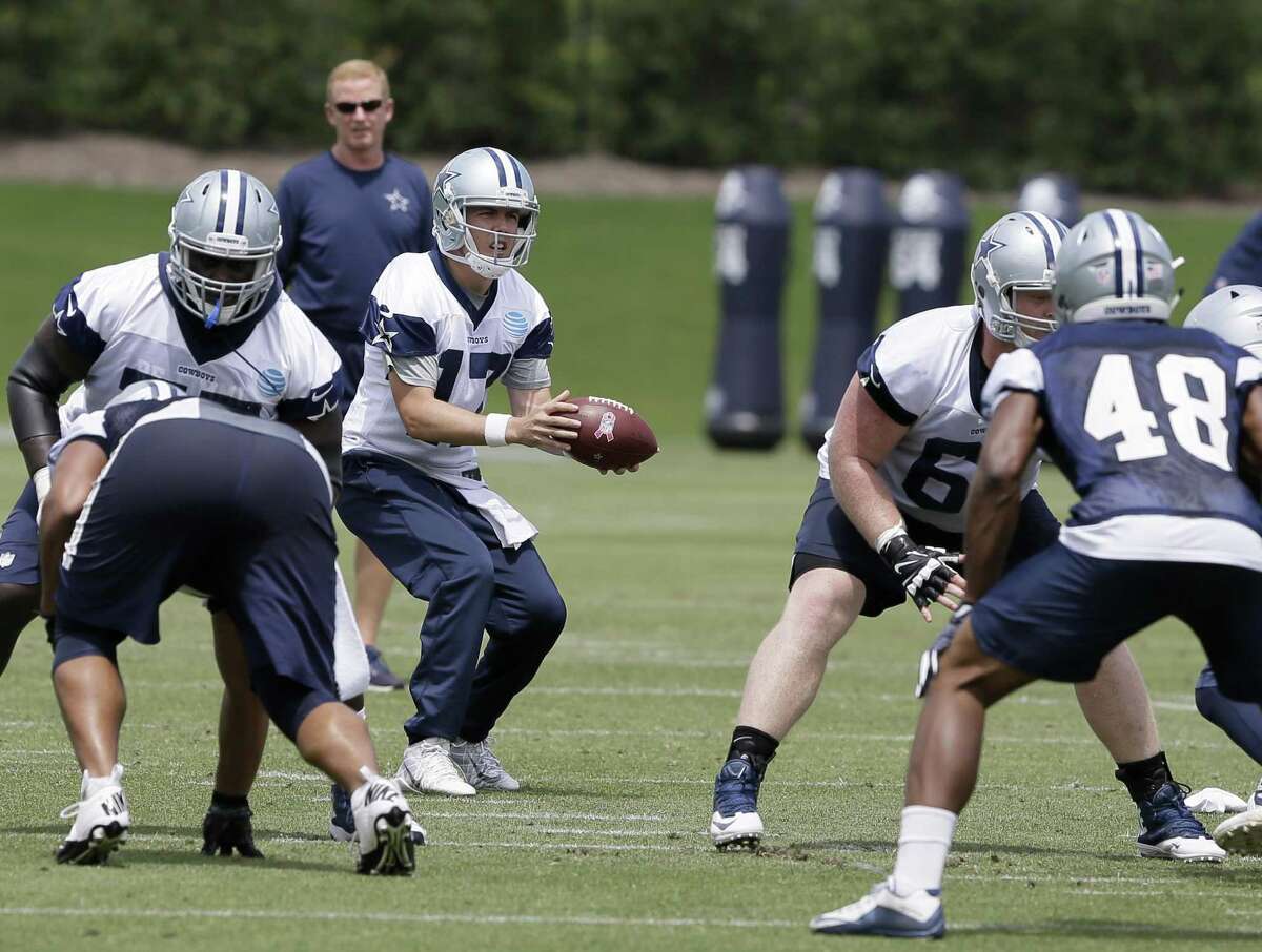 Cowboys’ Kellen Moore takes a snap during minicamp on June 14.