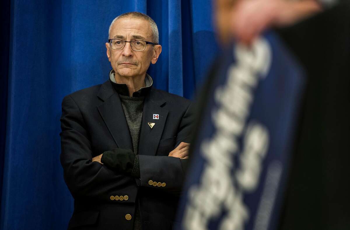 Campaign Chair John Podesta listens backstage to former Secretary of State Hillary Clinton at a rally in Cedar Rapids, Iowa on January 30, 2016; WikiLeaks' release of Podesta's emails reveal s occasionally harsh political assessments along with more domestic concerns. MUST CREDIT: Washington Post photo by Melina Mara.