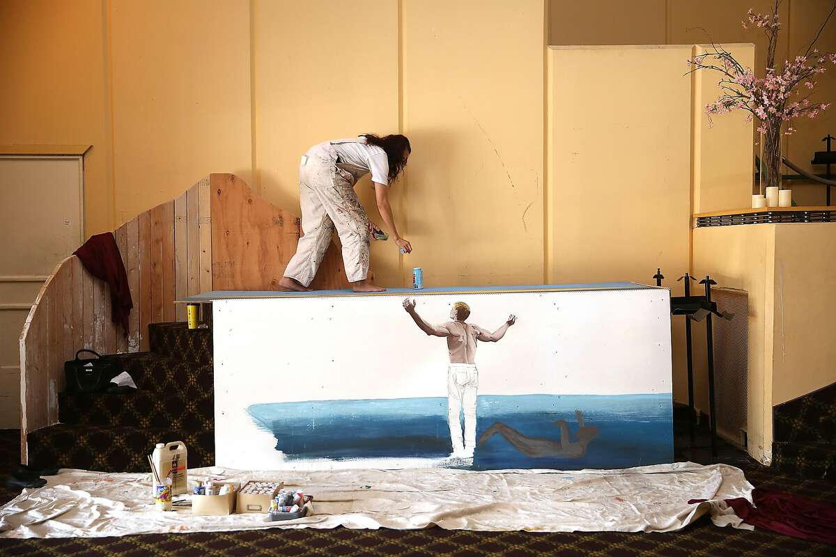 Teacher and artist Alexis Orth works on the baptismal in the church at Old Rey Theater in San Francisco , California, on Wednesday, February 10, 2016.