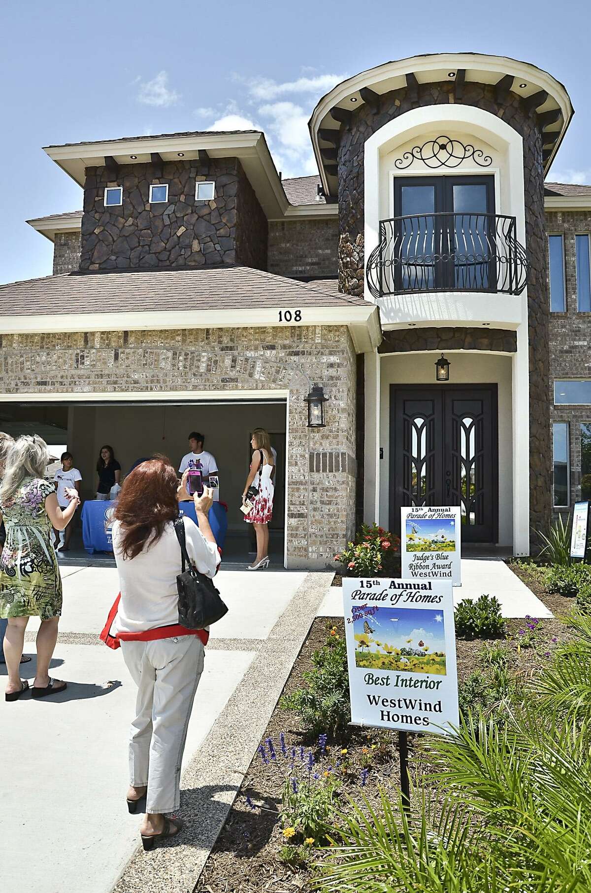 A woman photographs one of the 11 homes that participated in the 15th Annual Parade of Homes Sunday afternoon. The event, sponsored by the Laredo Builders Assocation, saw its biggest number of visitors in recent years.