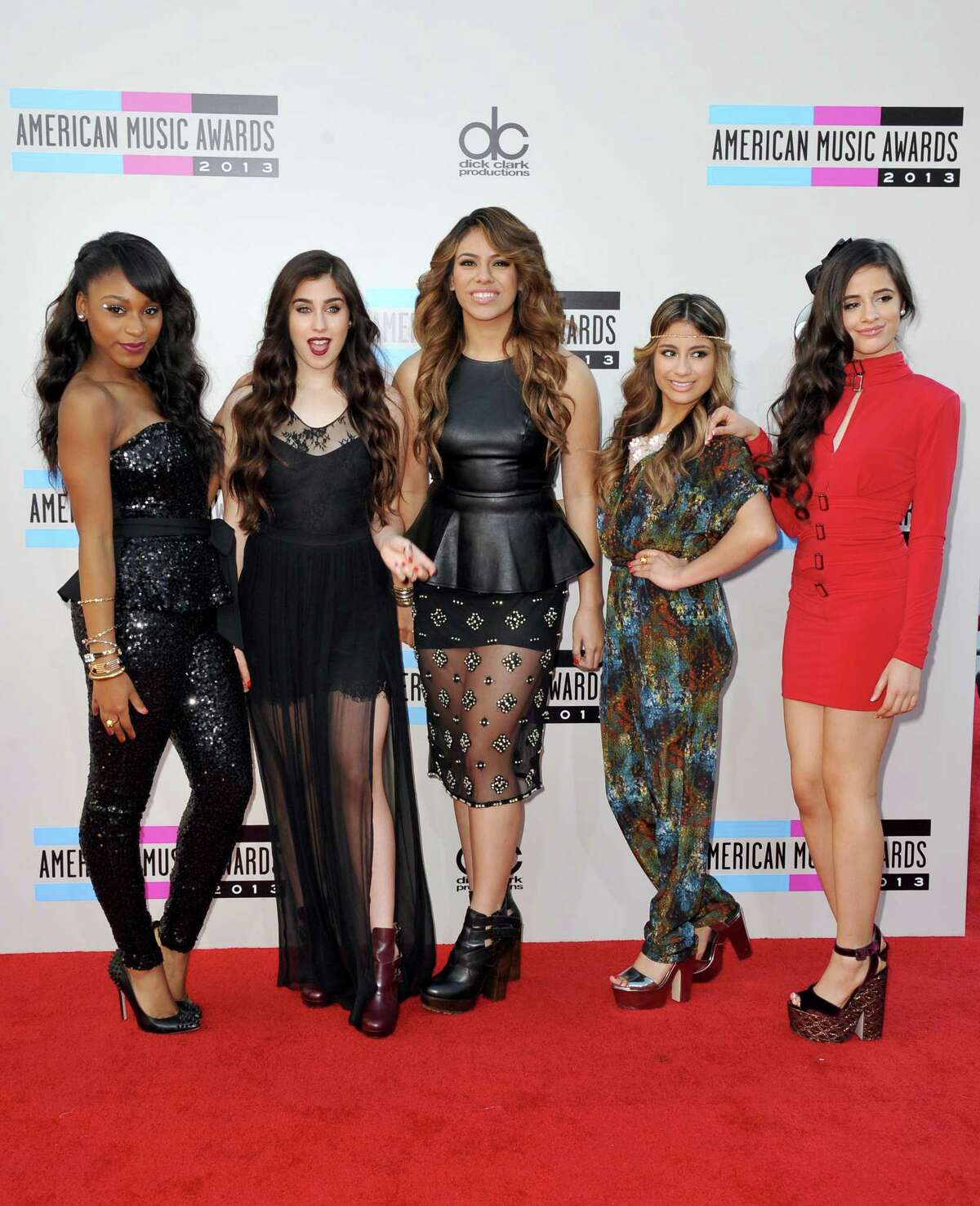 Members of Fifth Harmony, from left, Normani Kordei, Lauren Jauregui, Dinah Jane Hansen, Ally Brooke, and Camila Cabello arrive at the American Music Awards at the Nokia Theatre L.A. Live on Sunday, Nov. 24, 2013, in Los Angeles. (Photo by Jordan Strauss/Invision/AP) ORG XMIT: CACJ122