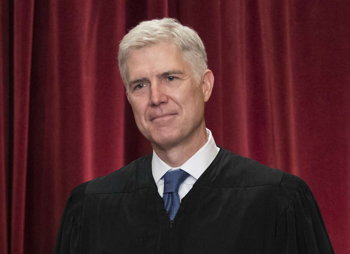 FILE - In this June 1, 2017, file photo Supreme Court Associate Justice Neil Gorsuch is seen during an official group portrait at the Supreme Court Building Washington. For those wondering where Gorsuch will fit on the Supreme Court’s ideological spectrum, the best early clue might be to watch the company he keeps. Gorsuch has already paired up four times with Justice Clarence Thomas _ the court’s most conservative member _ in separate opinions that dissent from or take issue with the court’s majority rulings. (AP Photo/J. Scott Applewhite, File)