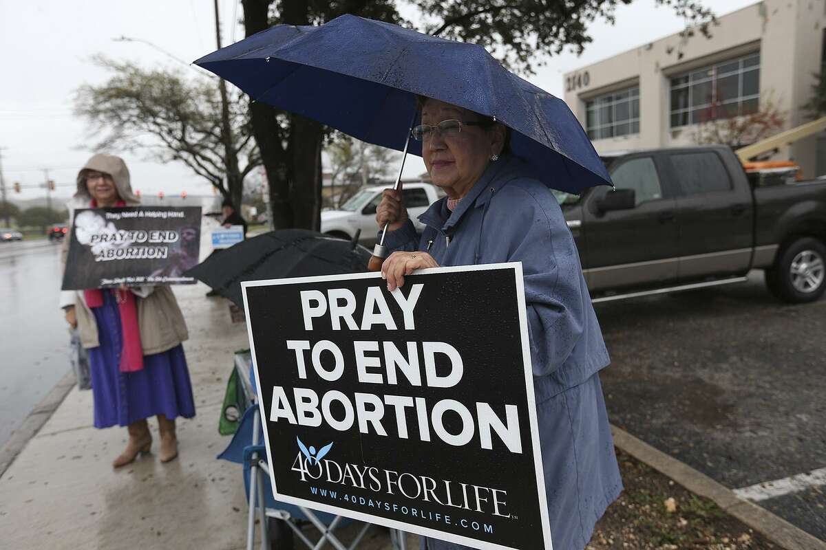 Mary Banda, right, and Sylvia Davila gather with others to pray and protest in front of the Planned Parenthood South Texas' new ambulatory surgical center for abortions at 2140 Babcock on March 9, 2015.