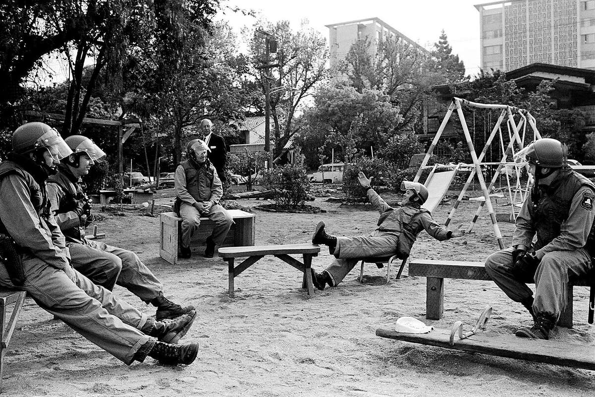 May 15, 1969 - Berkeley, California, USA: Alameda County Sheriff's sit on benches in People's Park after clearing it early one morning.� Students took over University land and made a park. Police cleared the park, a riot ensued. Police fired into the crowd killing a few people.